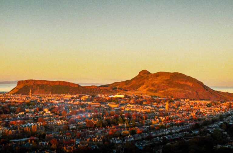 Arthur's Seat above Edinburgh rooftops in golden light