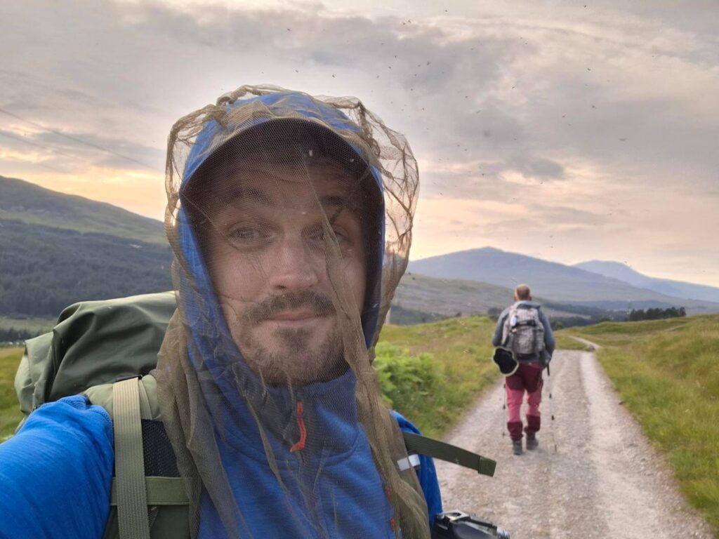 Selfie wearing a midge head net on the trail